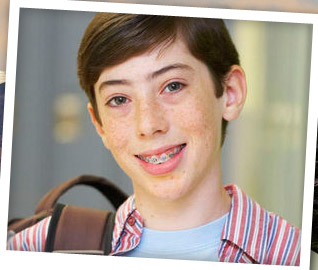 boy smiling and wearing braces